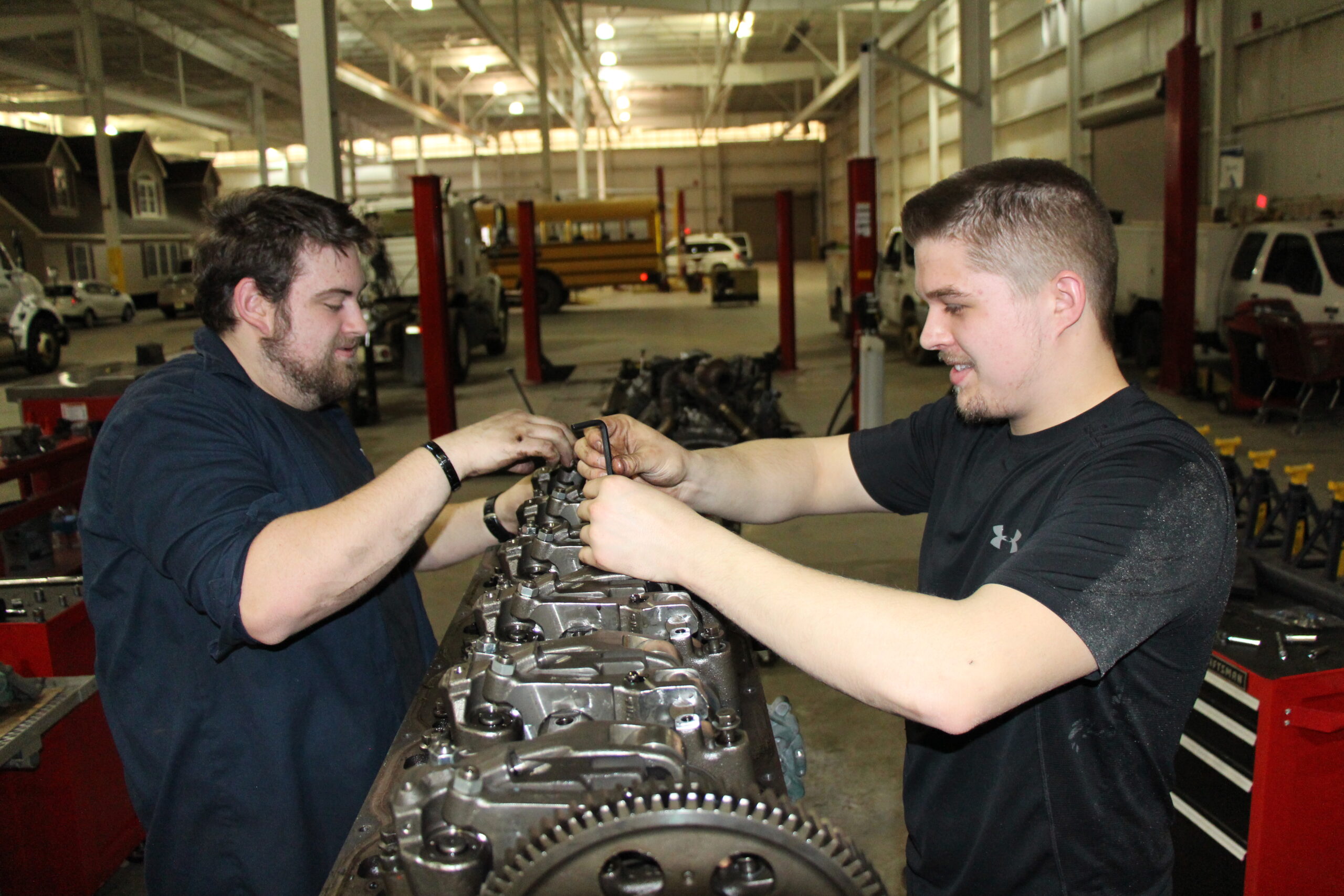 Diesel Service Technology program students work on assembling an engine.