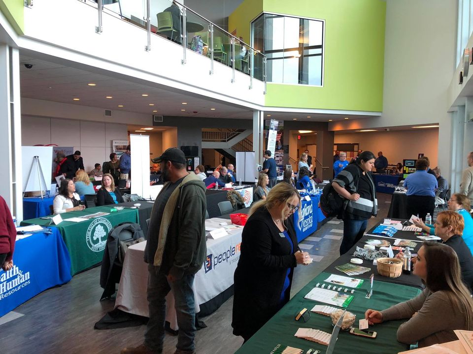 Students visit a variety of tables with potential employers in the lobby of Building 2000 as part of the institution's career fair.