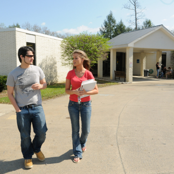 Two students walk in front of the main building on New River Community and Technical College's Nicholas County Campus